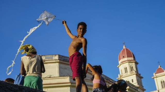 A youth flies a kite outside the shrine of the Virgin of Charity of Cobre in El Cobre, Cuba, on Saturday, Feb. 10, 2024. The Vatican-recognized Virgin, venerated by Catholics and followers of Afro-Cuban Santeria traditions, is at the heart of Cuban identity, uniting compatriots from the Communist-run Caribbean island to those who were exiled or emigrated to the U.S. (AP Photo/Ramon Espinosa) A youth flies a kite outside the shrine of the Virgin of Charity of Cobre in El Cobre, Cuba, on Saturday, Feb. 10, 2024. The Vatican-recognized Virgin, venerated by Catholics and followers of Afro-Cuban Santeria traditions, is at the heart of Cuban identity, uniting compatriots from the Communist-run Caribbean island to those who were exiled or emigrated to the U.S. (AP Photo/Ramon Espinosa)