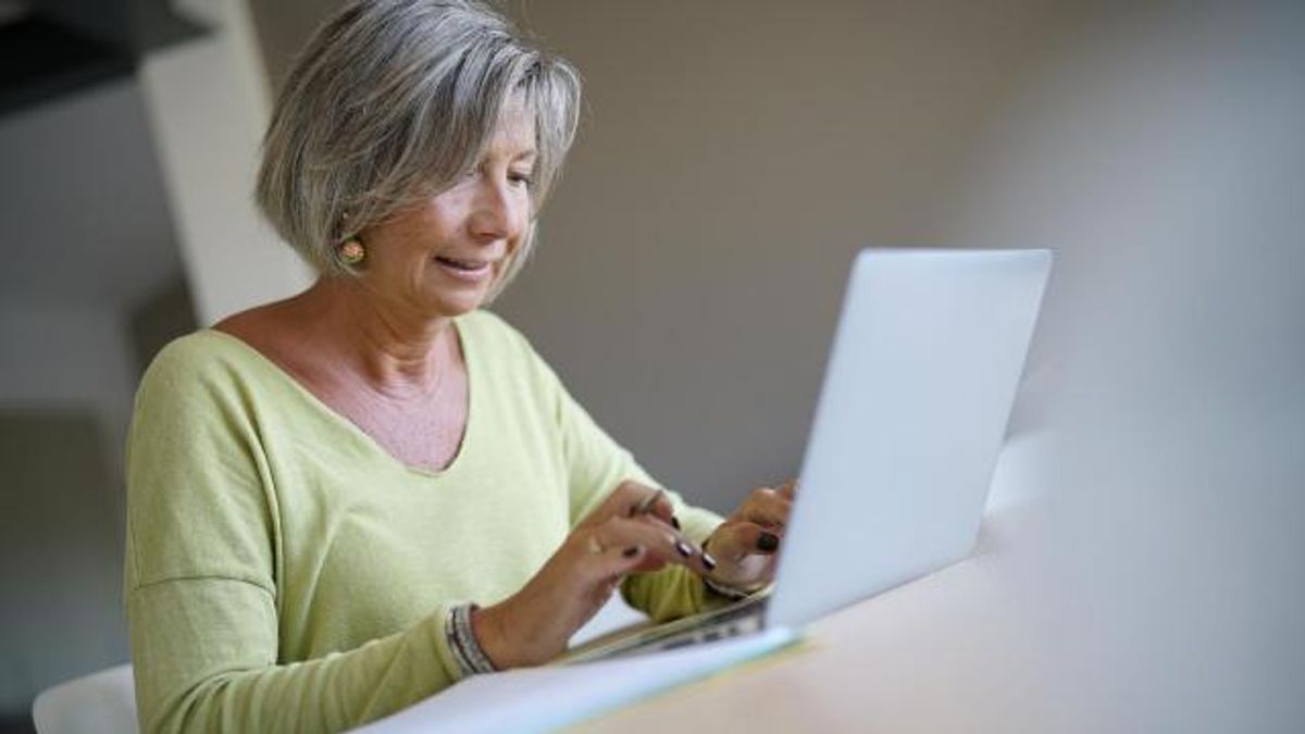 Senior woman at home using laptop computer