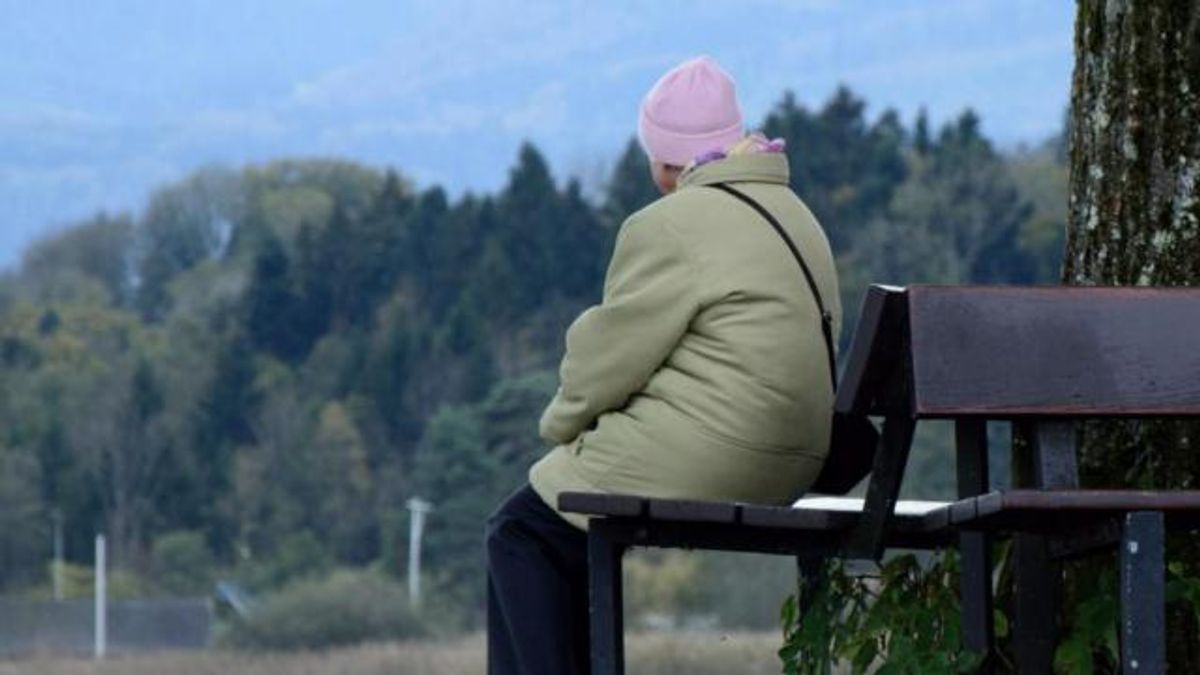 A woman sits alone