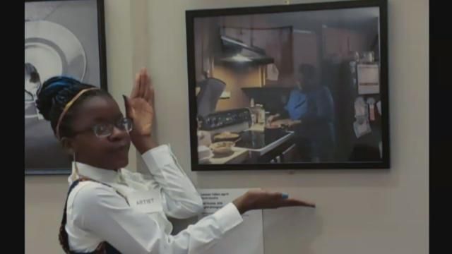 Lacquen Tolbert with photograph of her grandmother