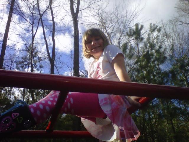 Amanda's daughter atop the monkey bars