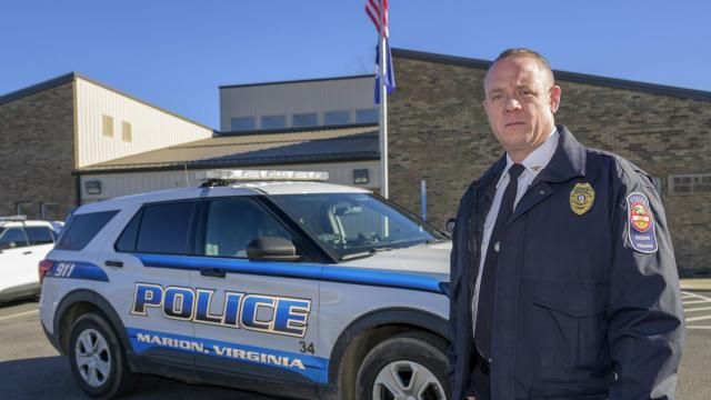 Marion Police Chief John Clair poses outside the Marion Police Department building, Monday, Feb. 5, 2024, in Marion, Va. Clair, chief of the small Appalachian town, spends his days consumed by a growing problem: the frequency with which his officers are tapped to detain, transport and wait in hospitals with people in the throes of a mental health crisis. (AP Photo/Earl Neikirk) Marion Police Chief John Clair poses outside the Marion Police Department building, Monday, Feb. 5, 2024, in Marion, Va. Clair, chief of the small Appalachian town, spends his days consumed by a growing problem: the frequency with which his officers are tapped to detain, transport and wait in hospitals with people in the throes of a mental health crisis. (AP Photo/Earl Neikirk)