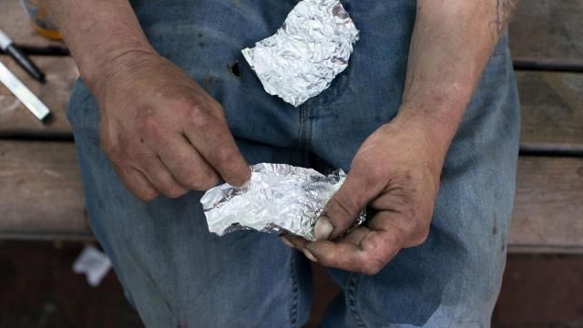 FILE - A man prepares to smoke fentanyl on a park bench in downtown Portland, Ore., on Thursday, May 18, 2023. Smoking has surpassed injecting as the most common way of taking drugs in U.S. overdose deaths, according to a study published by the Centers for Disease Control and Prevention on Thursday, Feb. 15, 2024. (Beth Nakamura/The Oregonian via AP, File) FILE - A man prepares to smoke fentanyl on a park bench in downtown Portland, Ore., on Thursday, May 18, 2023. Smoking has surpassed injecting as the most common way of taking drugs in U.S. overdose deaths, according to a study published by the Centers for Disease Control and Prevention on Thursday, Feb. 15, 2024. (Beth Nakamura/The Oregonian via AP, File)
