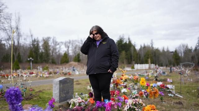 Evelyn Jefferson, a crisis outreach supervisor for Lummi Nation, stands at the grave of her son Patrick George Jr., who died last September due to an overdose of street drugs containing the synthetic opioid carfentanil, at the Lummi Nation cemetery on tribal reservation lands, Thursday, Feb. 8, 2024, near Bellingham, Wash. Jefferson had to wait a week to bury her son due to several other overdose deaths in the community. (AP Photo/Lindsey Wasson) Evelyn Jefferson, a crisis outreach supervisor for Lummi Nation, stands at the grave of her son Patrick George Jr., who died last September due to an overdose of street drugs containing the synthetic opioid carfentanil, at the Lummi Nation cemetery on tribal reservation lands, Thursday, Feb. 8, 2024, near Bellingham, Wash. Jefferson had to wait a week to bury her son due to several other overdose deaths in the community. (AP Photo/Lindsey Wasson)