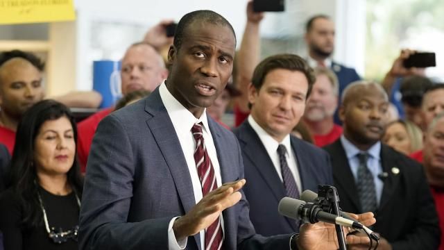 FILE - Florida Surgeon General Dr. Joseph Ladapo gestures as speaks to supporters and members of the media before a bill signing by Gov. Ron DeSantis Thursday, Nov. 18, 2021, in Brandon, Fla. Florida's controversial surgeon general is drawing criticism for his handling of an elementary school's measles outbreak, telling parents of unvaccinated children it is their choice whether their student attends class — a direct contravention of federal guidelines. (AP Photo/Chris O'Meara, File) FILE - Florida Surgeon General Dr. Joseph Ladapo gestures as speaks to supporters and members of the media before a bill signing by Gov. Ron DeSantis Thursday, Nov. 18, 2021, in Brandon, Fla. Florida's controversial surgeon general is drawing criticism for his handling of an elementary school's measles outbreak, telling parents of unvaccinated children it is their choice whether their student attends class — a direct contravention of federal guidelines. (AP Photo/Chris O'Meara, File)