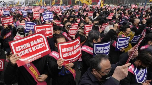 FILE - Doctors stage a rally against the government's medical policy in Seoul, South Korea, on March 3, 2024. South Korean authorities have suspended the licenses of two senior doctors for allegedly inciting the weekslong walkouts by medical interns and residents that disrupted hospital operations across the country. That's according to one of the doctors who spoke to The Associated Press. The suspensions are the government’s first punitive step against physicians after thousands of doctors-in-training walked off the job last month to protest the government’s plan to sharply increase medical school admissions. (AP Photo/Ahn Young-joon, File) FILE - Doctors stage a rally against the government's medical policy in Seoul, South Korea, on March 3, 2024. South Korean authorities have suspended the licenses of two senior doctors for allegedly inciting the weekslong walkouts by medical interns and residents that disrupted hospital operations across the country. That's according to one of the doctors who spoke to The Associated Press. The suspensions are the government’s first punitive step against physicians after thousands of doctors-in-training walked off the job last month to protest the government’s plan to sharply increase medical school admissions. (AP Photo/Ahn Young-joon, File)