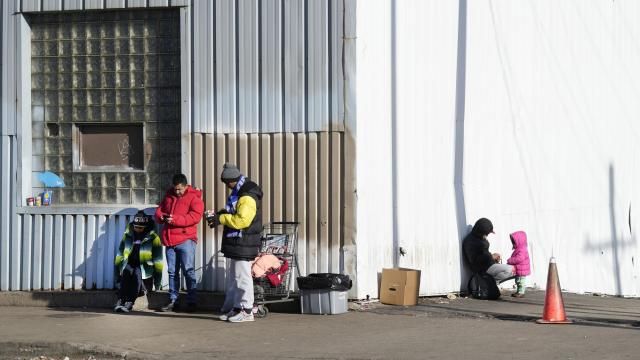 FILE - Immigrants stand outside a shelter in the Pilsen neighborhood of Chicago, Dec. 19, 2023. Officials have confirmed seven cases of measles among shelter residents since Thursday, March 7, 2024, prompting a push to boost vaccinations with support from the Centers for Disease Control and Prevention. (AP Photo/Charles Rex Arbogast, File) FILE - Immigrants stand outside a shelter in the Pilsen neighborhood of Chicago, Dec. 19, 2023. Officials have confirmed seven cases of measles among shelter residents since Thursday, March 7, 2024, prompting a push to boost vaccinations with support from the Centers for Disease Control and Prevention. (AP Photo/Charles Rex Arbogast, File)