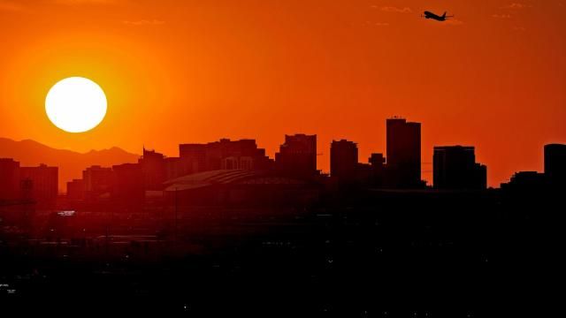 FILE - A jet takes flight from Sky Harbor International Airport as the sun sets over Phoenix, July 12, 2023. Public health officials in Arizona’s most populous county on Wednesday, March 13, 2024 reported it has confirmed there were a staggering 645 heat-associated deaths last year — another consecutive annual record in arid metro Phoenix. The numbers in the preliminary report alarmed officials in America's hottest big city and county, raising concerns about how to better protect vulnerable groups such as homeless people and older adults from the blistering summer heat. (AP Photo/Matt York, File) FILE - A jet takes flight from Sky Harbor International Airport as the sun sets over Phoenix, July 12, 2023. Public health officials in Arizona’s most populous county on Wednesday, March 13, 2024 reported it has confirmed there were a staggering 645 heat-associated deaths last year — another consecutive annual record in arid metro Phoenix. The numbers in the preliminary report alarmed officials in America's hottest big city and county, raising concerns about how to better protect vulnerable groups such as homeless people and older adults from the blistering summer heat. (AP Photo/Matt York, File)