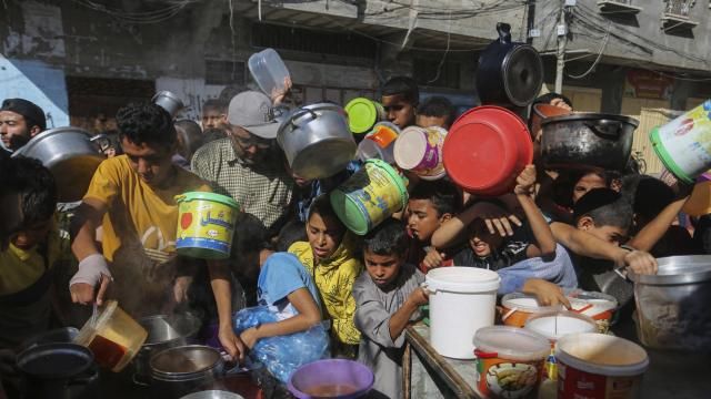 FILE - Palestinians crowd together as they wait for food distribution in Rafah, southern Gaza Strip, Nov. 8, 2023. Catastrophic hunger is so dire in two world hotspots that famine is imminent in northern Gaza and approaching in Haiti, with hundreds of thousands of people in both places struggling to avoid starvation, according to international food security experts and aid groups. (AP Photo/Hatem Ali, File) FILE - Palestinians crowd together as they wait for food distribution in Rafah, southern Gaza Strip, Nov. 8, 2023. Catastrophic hunger is so dire in two world hotspots that famine is imminent in northern Gaza and approaching in Haiti, with hundreds of thousands of people in both places struggling to avoid starvation, according to international food security experts and aid groups. (AP Photo/Hatem Ali, File)