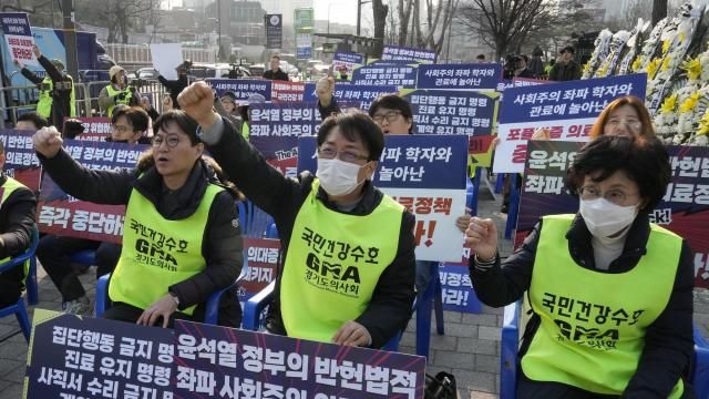 Members of the Gyeonggi Province Medical Association stage a rally against the government's medical policy near the presidential office in Seoul, South Korea, Wednesday, March 13, 2024. South Korea's government criticized senior doctors at a major hospital Tuesday for threatening to resign in support of the weekslong walkouts by thousands of medical interns and residents that have disrupted hospital operations. The banners read "Stop President Yoon Suk Yeol government's medical policy." (AP Photo/Ahn Young-joon) Members of the Gyeonggi Province Medical Association stage a rally against the government's medical policy near the presidential office in Seoul, South Korea, Wednesday, March 13, 2024. South Korea's government criticized senior doctors at a major hospital Tuesday for threatening to resign in support of the weekslong walkouts by thousands of medical interns and residents that have disrupted hospital operations. The banners read "Stop President Yoon Suk Yeol government's medical policy." (AP Photo/Ahn Young-joon)