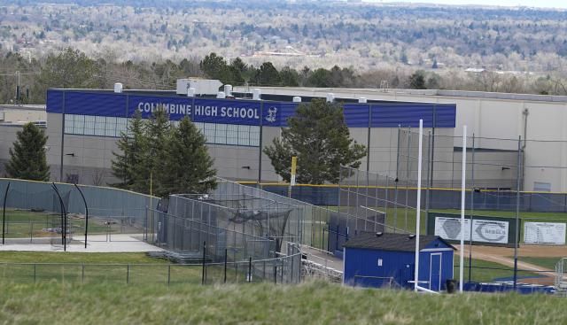 A view of Columbine High School from rebel hill at the Columbine Memorial, Wednesday, April 17, 2024, in Littleton, Colo. Trauma still shadows the survivors of the horrific Columbine High School shooting as the attack's 25th anniversary approaches. (AP Photo/David Zalubowski)