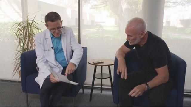 **This image is for use with this specific article only** Dr. Richard Isaacson, left, discusses test results with Simon Nicholls, participant No. 34 in his clinical trial.
Mandatory Credit: CNN via CNN Newsource.