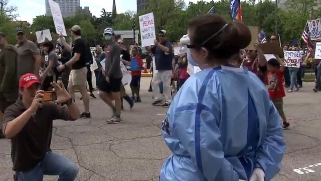 Health care workers stage silent counter-protest to calls for reopening NC economy amid pandemic