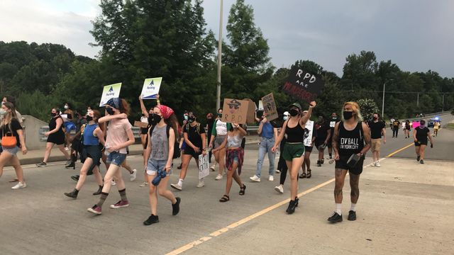Protesters from NC BORN marching on Falls of Neuse Road