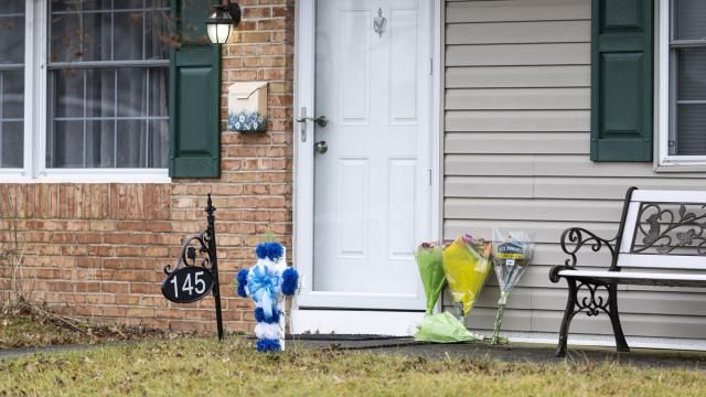 FILE - Flowers rest at the front door of the Mohn residence in Upper Orchard section in Levittown, Pa., on Friday, Feb. 2, 2024. Authorities have added more charges, including terrorism, against Justin Mohn, the Pennsylvania man charged with fatally shooting his father, decapitating him and posting a video online in which he held up the severed head. (Tyger Williams/The Philadelphia Inquirer via AP) FILE - Flowers rest at the front door of the Mohn residence in Upper Orchard section in Levittown, Pa., on Friday, Feb. 2, 2024. Authorities have added more charges, including terrorism, against Justin Mohn, the Pennsylvania man charged with fatally shooting his father, decapitating him and posting a video online in which he held up the severed head. (Tyger Williams/The Philadelphia Inquirer via AP)