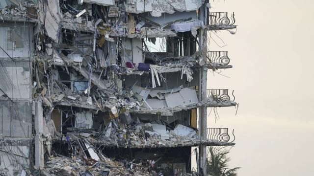 FILE - A giant tarp, bottom, covers a section of rubble at the Champlain Towers South condo building, July 4, 2021, in Surfside, Fla. Federal investigators determining why the Florida condominium tower partially collapsed three years ago, killing 98 people, said Thursday, March 7, 2024, that there were many faulty support columns in the tenant garage that ran below it and the adjoining pool deck. (AP Photo/Lynne Sladky, File) FILE - A giant tarp, bottom, covers a section of rubble at the Champlain Towers South condo building, July 4, 2021, in Surfside, Fla. Federal investigators determining why the Florida condominium tower partially collapsed three years ago, killing 98 people, said Thursday, March 7, 2024, that there were many faulty support columns in the tenant garage that ran below it and the adjoining pool deck. (AP Photo/Lynne Sladky, File)