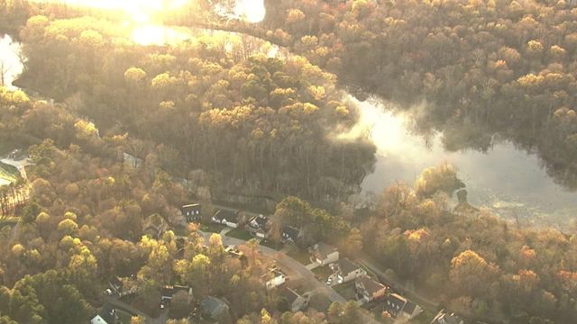 Sky 5 flies over fire near Neuse River in Wake Forest