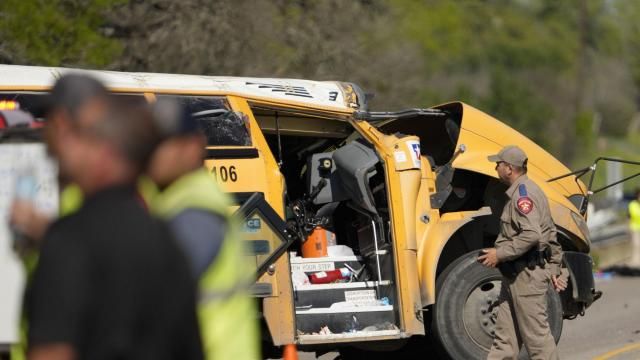 A Texas Department of Public Safety trooper inspects the scene of a fatal school bus crash on Texas State Highway 21 near Caldwell Road on Friday, March 22, 2024, in Bastrop, Texas. Texas authorities say a school bus with more than 40 pre-K students collided with a concrete truck and rolled over while returning from a field trip, killing a boy on the bus and a man in another vehicle. (Jay Janner/Austin American-Statesman via AP) A Texas Department of Public Safety trooper inspects the scene of a fatal school bus crash on Texas State Highway 21 near Caldwell Road on Friday, March 22, 2024, in Bastrop, Texas. Texas authorities say a school bus with more than 40 pre-K students collided with a concrete truck and rolled over while returning from a field trip, killing a boy on the bus and a man in another vehicle. (Jay Janner/Austin American-Statesman via AP)