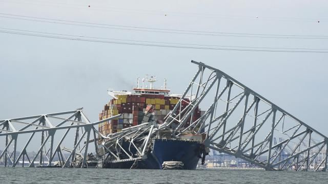 A Coast Guard helicopter passes a cargo ship that is stuck under the part of the structure of the Francis Scott Key Bridge after the ship his the bridge Tuesday March 26, 2024, in Baltimore, Md. (AP Photo/Steve Helber) A Coast Guard helicopter passes a cargo ship that is stuck under the part of the structure of the Francis Scott Key Bridge after the ship his the bridge Tuesday March 26, 2024, in Baltimore, Md. (AP Photo/Steve Helber)