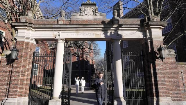 CORRECTS DOLLAR AMOUNT FROM $90,000 TO $95,000 - FILE - A passer-by walks through a gate to the Harvard University campus, Jan. 2, 2024, in Cambridge, Mass. As more than 2 million graduating high school students from across the United States finalize their decisions on what college to attend this fall, many are facing jaw-dropping costs — in some cases, as much as $95,000. (AP Photo/Steven Senne, File) CORRECTS DOLLAR AMOUNT FROM $90,000 TO $95,000 - FILE - A passer-by walks through a gate to the Harvard University campus, Jan. 2, 2024, in Cambridge, Mass. As more than 2 million graduating high school students from across the United States finalize their decisions on what college to attend this fall, many are facing jaw-dropping costs — in some cases, as much as $95,000. (AP Photo/Steven Senne, File)