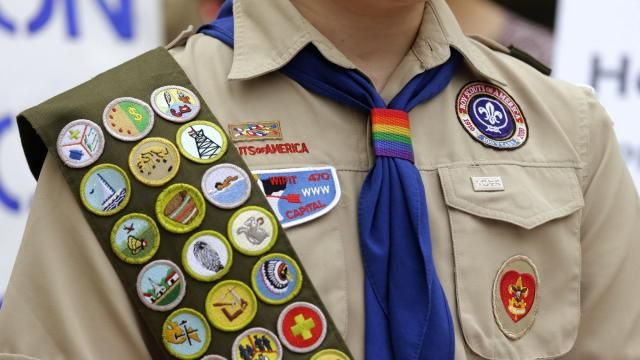 FILE - Merit badges and a rainbow-colored neckerchief slider are affixed on a Boy Scout uniform outside the headquarters of Amazon in Seattle. The U.S. organization, which now welcomes girls into the program and allows them to work toward the coveted Eagle Scout rank, announced Tuesday, May 7, 2024, that it will change its name to Scouting America as it focuses on inclusion. (AP Photo/Ted S. Warren, File) FILE - Merit badges and a rainbow-colored neckerchief slider are affixed on a Boy Scout uniform outside the headquarters of Amazon in Seattle. The U.S. organization, which now welcomes girls into the program and allows them to work toward the coveted Eagle Scout rank, announced Tuesday, May 7, 2024, that it will change its name to Scouting America as it focuses on inclusion. (AP Photo/Ted S. Warren, File)