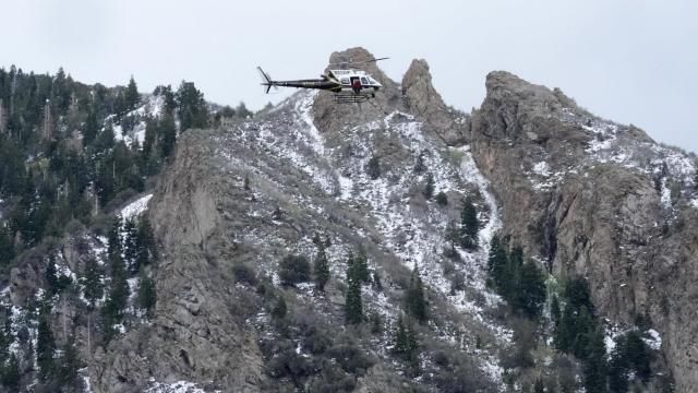 A Utah Department of Public Safety helicopter carries rescuers from Hidden Valley Park on Thursday, May 9, 2024, Thursday, May 9, 2024, in Sandy, Utah. One skier was rescued and two remained missing following an avalanche in the mountains outside of Salt Lake City. The slide happened after several days of spring snowstorms. (AP Photo/Rick Bowmer)