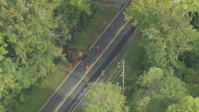 Sky 5 flies over washed out road in Orange County