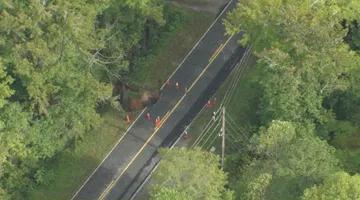 Sky 5 flies over washed out road in Orange County