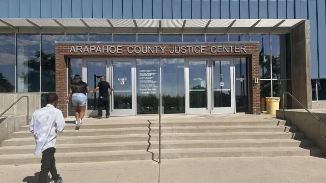 People enter the Arapahoe County Justice Center in Centennial, Colo., on Monday, July 14, 2025. (AP Photo/Thomas Peipert)