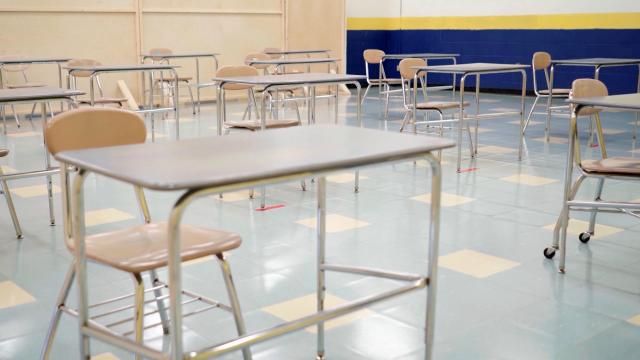 In the classroom in Fall 2020, desks are removed and others spread out to allow for social distance.