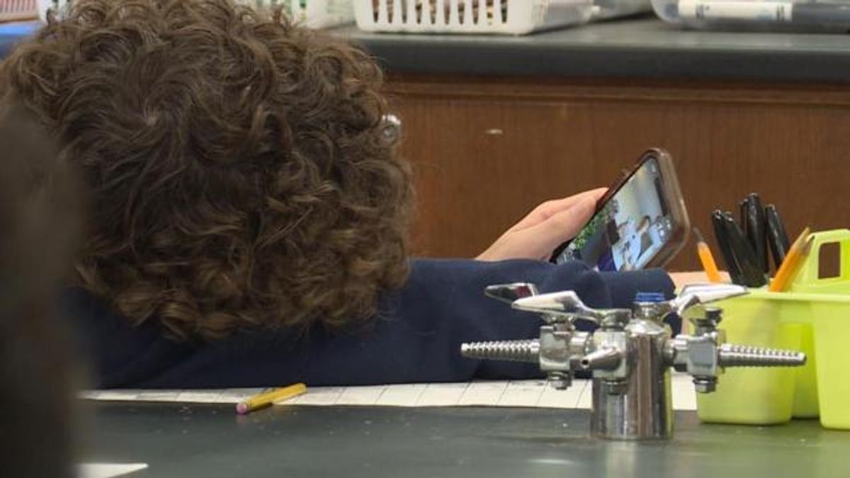 Enloe Magnet High School student scrolls on cellphone