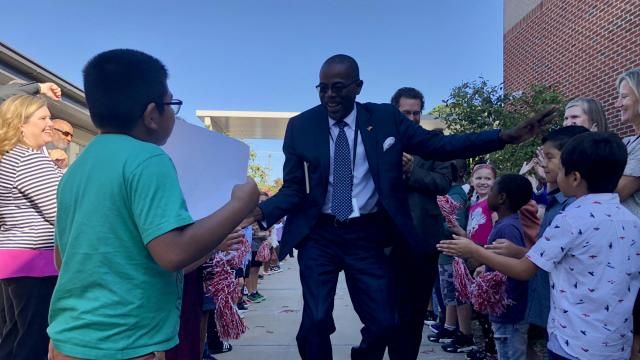 Robert Taylor greets Rolesville Elementary School students Oct. 2, 2023. It's the first of a planned 197 school visits for Taylor this year. Emily Walkenhorst/WRAL News