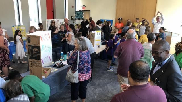 Wake County Public School System Superintendent Robert Taylor (right corner) talks with attendees at WakeEd Partnership's annual STEMposium. The event showcases hands-on classroom projects that Taylor touted as important for learning and career readiness. WRAL/Emily Walkenhorst
