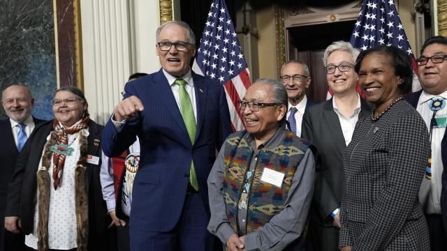 Washington Gov. Jay Inslee, third from left, stands with Chair Gerry Lewis of the Yakama Nation, fourth from left, as they and others pose for a photo following a ceremonial signing ceremony in Washington, Friday, Feb. 23, 2024. The ceremonial signing is an agreement between the Biden administration and state and Tribal governments to work together to protect salmon and other native fish, honor obligations to Tribal nations, and recognize the important services the Columbia River System provides to the economy of the Pacific Northwest. (AP Photo/Susan Walsh) Washington Gov. Jay Inslee, third from left, stands with Chair Gerry Lewis of the Yakama Nation, fourth from left, as they and others pose for a photo following a ceremonial signing ceremony in Washington, Friday, Feb. 23, 2024. The ceremonial signing is an agreement between the Biden administration and state and Tribal governments to work together to protect salmon and other native fish, honor obligations to Tribal nations, and recognize the important services the Columbia River System provides to the economy of the Pacific Northwest. (AP Photo/Susan Walsh)