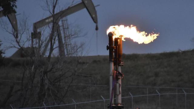 FILE - A flare burns at a well pad Aug. 26, 2021, near Watford City, N.D. American oil and natural gas wells, pipelines and compressors are spewing three times the amount of the potent heat-trapping gas methane as the government thinks, a new comprehensive study calculates. (AP Photo/Matthew Brown, File) FILE - A flare burns at a well pad Aug. 26, 2021, near Watford City, N.D. American oil and natural gas wells, pipelines and compressors are spewing three times the amount of the potent heat-trapping gas methane as the government thinks, a new comprehensive study calculates. (AP Photo/Matthew Brown, File)