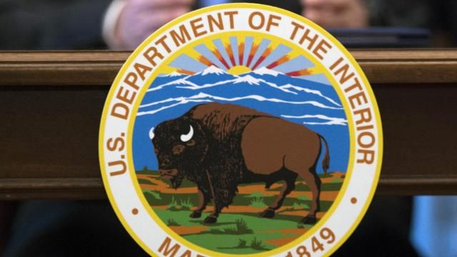 FILE - The Interior Department in Washington, March 29, 2017. The Interior Department will be allocating more than $120 million to tribal governments to fight the impacts of climate change. The funding is designed to help tribal nations adapt to climate threats, including relocating infrastructure. (AP Photo/Molly Riley) FILE - The Interior Department in Washington, March 29, 2017. The Interior Department will be allocating more than $120 million to tribal governments to fight the impacts of climate change. The funding is designed to help tribal nations adapt to climate threats, including relocating infrastructure. (AP Photo/Molly Riley)