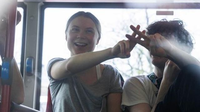 Climate activist Greta Thunberg flashes a V-sign after being detained and driven off in a bus after joining protestors who blocked a road during a climate protest by Extinction Rebellion and other activists near the Dutch parliament in The Hague, Netherlands, Saturday, April 6, 2024. (AP Photo/Peter Dejong) Climate activist Greta Thunberg flashes a V-sign after being detained and driven off in a bus after joining protestors who blocked a road during a climate protest by Extinction Rebellion and other activists near the Dutch parliament in The Hague, Netherlands, Saturday, April 6, 2024. (AP Photo/Peter Dejong)
