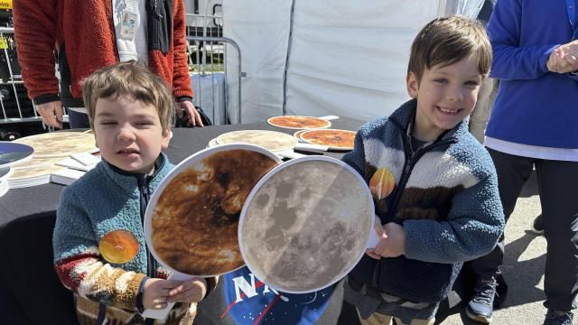 Gabriel Kauffman, 4, and his brother, Theodore, 6, demonstrate a total solar eclipse at a NASA booth at the Great Lakes Science Center in Cleveland, on Sunday, April 7, 2024. They live in Baltimore and came to the Cleveland area to see the eclipse with relatives. (AP Photo/Stephanie Nano) Gabriel Kauffman, 4, and his brother, Theodore, 6, demonstrate a total solar eclipse at a NASA booth at the Great Lakes Science Center in Cleveland, on Sunday, April 7, 2024. They live in Baltimore and came to the Cleveland area to see the eclipse with relatives. (AP Photo/Stephanie Nano)