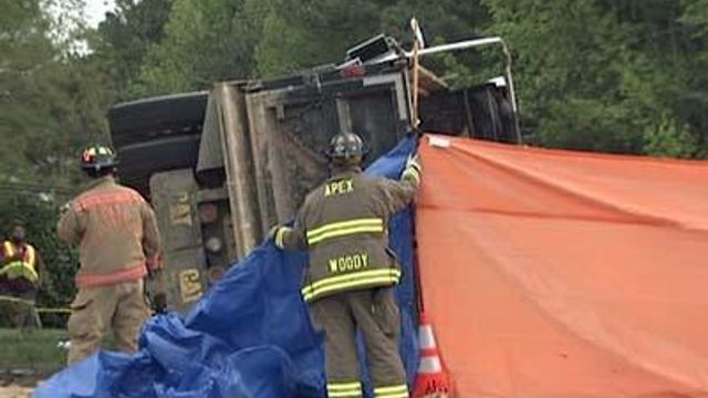 Woman pinned after dump truck overturns