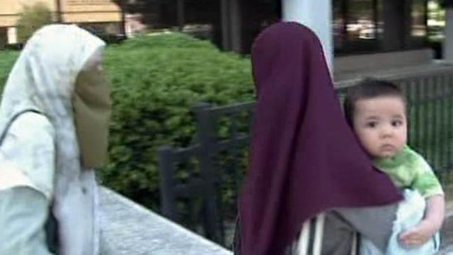Terror suspect sees infant son in court