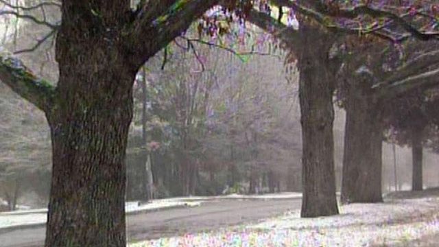 Early snow leaves slick roads behind