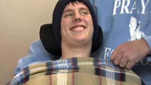 Student paralyzed in football game returns home