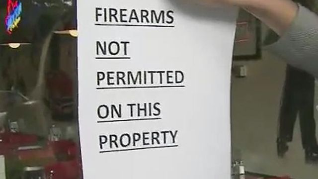 Signs barring guns could keep customers away