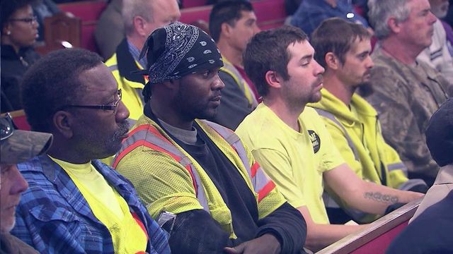 Work pauses so colleagues can honor victims of scaffolding collapse