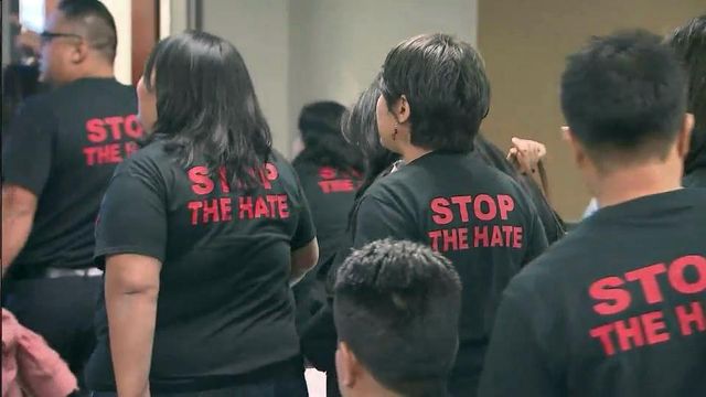 Protesters march out of meeting on immigration enforcement program
