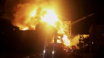 Crane falls as massive fire burns in Raleigh