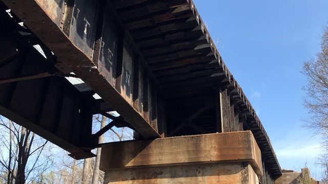 Truck damages Apex railroad bridge, closing tracks and street below