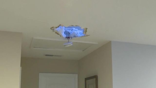 Flying debirs put hole through roof of Durham home