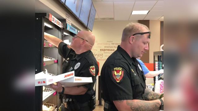 Holly Springs police officers serve breakfast treats for a good cause