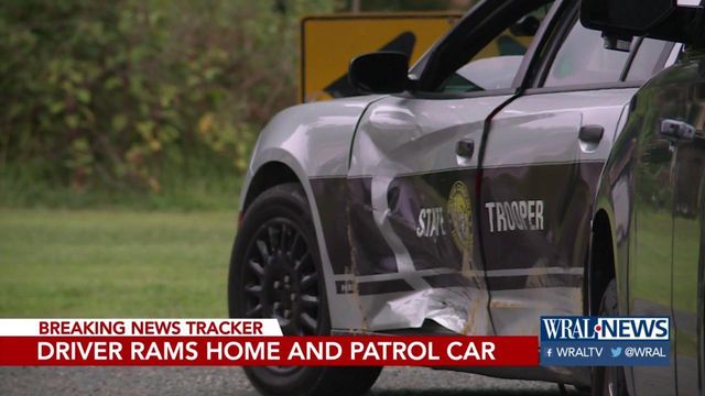 Woman rams vehicle into house, highway patrol car